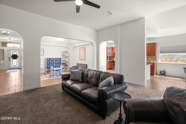 14328 N Cave Dr, El Paso, TX 79938 - living area with arched walkways, light tile patterned floors, and ceiling fan