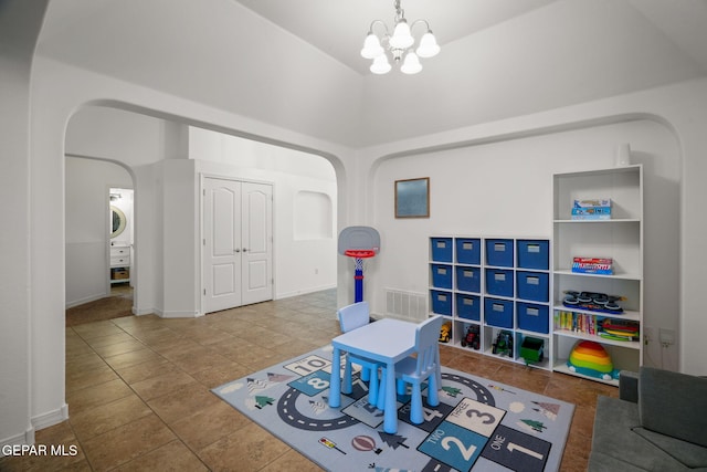 14328 N Cave Dr, El Paso, TX 79938 - rec room featuring arched walkways, a towering ceiling, tile patterned floors, a chandelier, and washer / clothes dryer