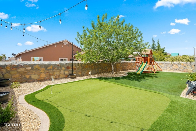14328 N Cave Dr, El Paso, TX 79938 - fenced backyard featuring a putting green and a playground