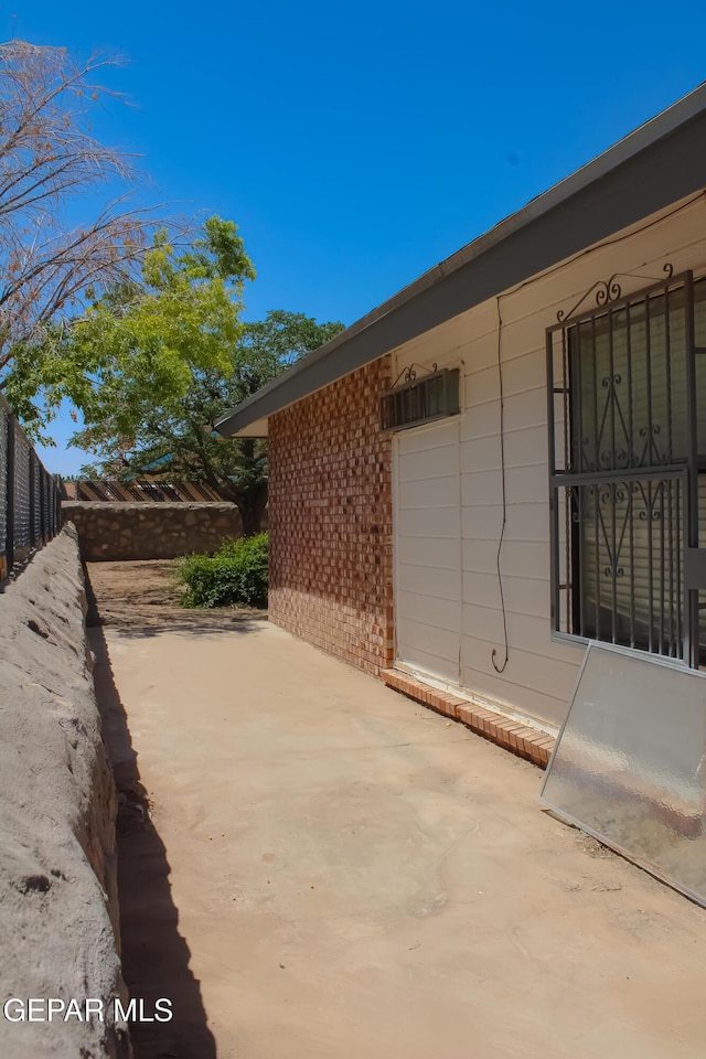 2445 Nancy Mcdonald Dr, El Paso, TX 79936 - view of side of home featuring a patio and brick siding