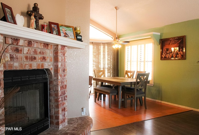 2445 Nancy Mcdonald Dr, El Paso, TX 79936 - dining area featuring vaulted ceiling, wood finished floors, a fireplace, ceiling fan, and baseboards