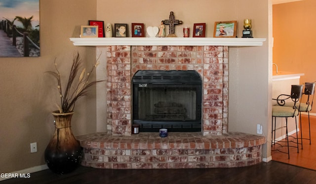 2445 Nancy Mcdonald Dr, El Paso, TX 79936 - detailed view of baseboards, wood finished floors, and a brick fireplace