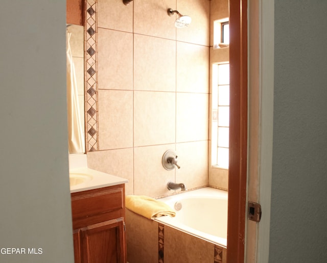 2445 Nancy Mcdonald Dr, El Paso, TX 79936 - bathroom featuring healthy amount of natural light, vanity, and tile walls