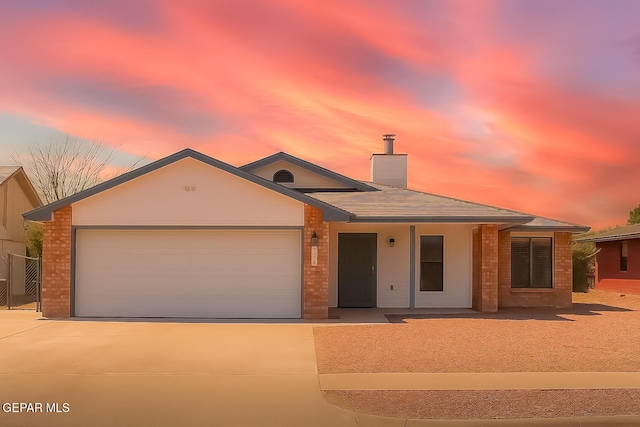 2445 Nancy Mcdonald Dr, El Paso, TX 79936 - ranch-style home featuring driveway, brick siding, an attached garage, and a chimney