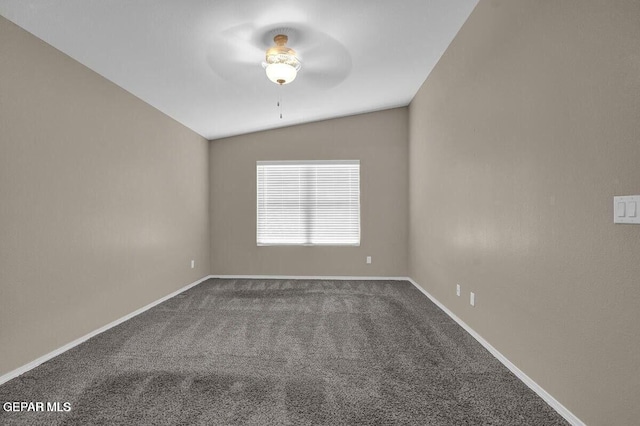 unfurnished room with ceiling fan, carpet floors, vaulted ceiling, and baseboards