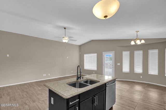 kitchen featuring a sink, stainless steel dishwasher, open floor plan, dark cabinetry, and lofted ceiling