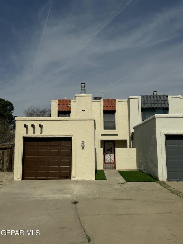 191 Mulberry Ave Unit G, El Paso, TX 79932 - view of front of property with concrete driveway, stucco siding, and a garage
