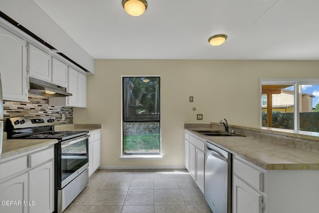 191 Mulberry Ave Unit G, El Paso, TX 79932 - kitchen with appliances with stainless steel finishes, under cabinet range hood, a sink, a peninsula, and decorative backsplash