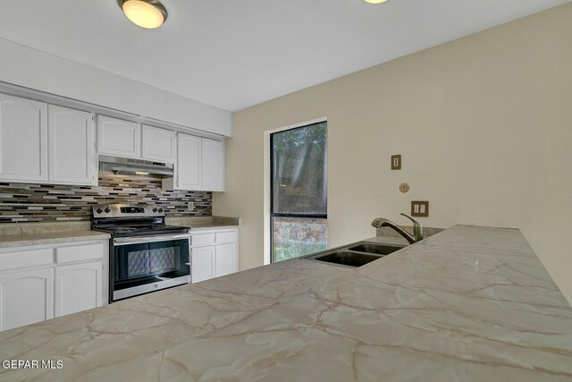 191 Mulberry Ave Unit G, El Paso, TX 79932 - kitchen with electric stove, under cabinet range hood, a sink, decorative backsplash, and white cabinetry