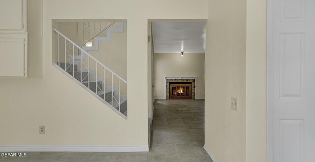 191 Mulberry Ave Unit G, El Paso, TX 79932 - staircase with a glass covered fireplace, baseboards, and tile patterned flooring