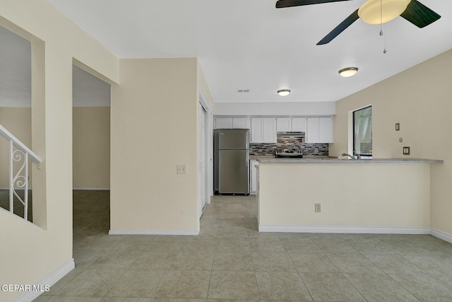 191 Mulberry Ave Unit G, El Paso, TX 79932 - kitchen featuring appliances with stainless steel finishes, a peninsula, white cabinets, backsplash, and light tile patterned flooring