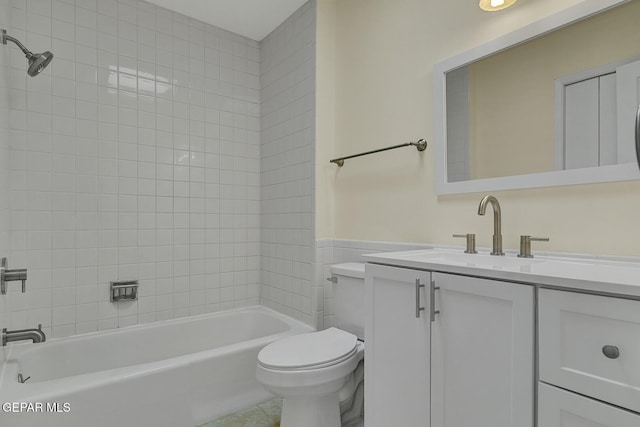191 Mulberry Ave Unit G, El Paso, TX 79932 - full bathroom with toilet, vanity, tub / shower combination, wainscoting, and tile walls