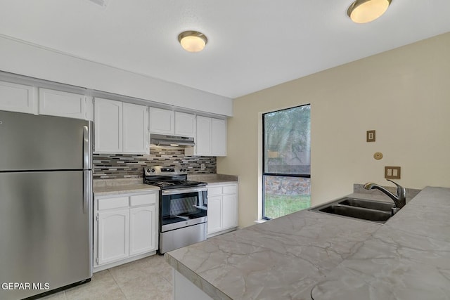 191 Mulberry Ave Unit G, El Paso, TX 79932 - kitchen with appliances with stainless steel finishes, a sink, under cabinet range hood, white cabinets, and tasteful backsplash
