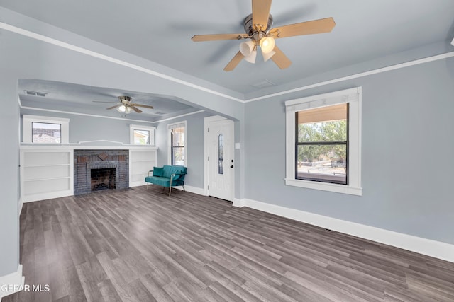 4301 Hueco Ave, El Paso, TX 79903 - unfurnished living room featuring a ceiling fan, baseboards, wood finished floors, and a brick fireplace