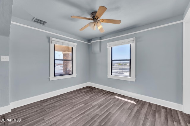 4301 Hueco Ave, El Paso, TX 79903 - spare room featuring dark wood finished floors, baseboards, and a ceiling fan