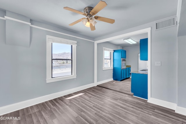 4301 Hueco Ave, El Paso, TX 79903 - spare room with baseboards, a ceiling fan, and wood finished floors