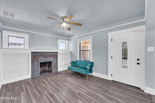 4301 Hueco Ave, El Paso, TX 79903 - entryway featuring baseboards, a brick fireplace, wood finished floors, and a ceiling fan
