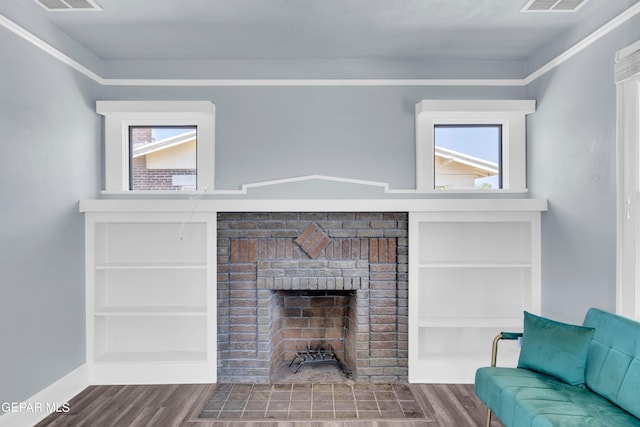 4301 Hueco Ave, El Paso, TX 79903 - living area featuring wood finished floors, plenty of natural light, a brick fireplace, and baseboards