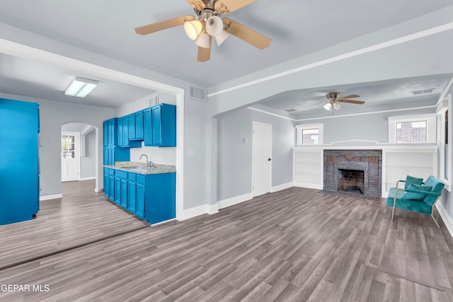 4301 Hueco Ave, El Paso, TX 79903 - unfurnished living room featuring ceiling fan, a sink, arched walkways, and baseboards