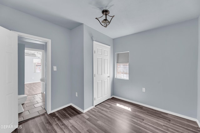 4301 Hueco Ave, El Paso, TX 79903 - unfurnished bedroom featuring wood finished floors and baseboards