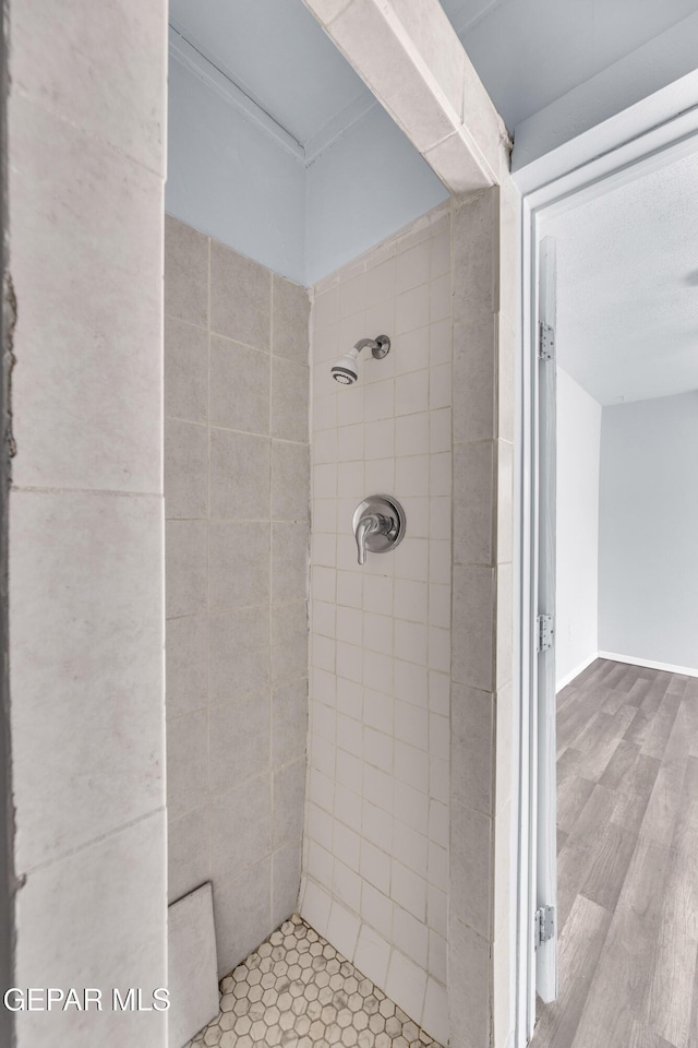 4301 Hueco Ave, El Paso, TX 79903 - full bathroom with tiled shower and wood finished floors