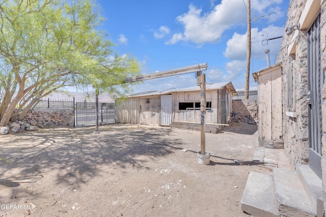 4301 Hueco Ave, El Paso, TX 79903 - view of yard featuring fence, a gate, and an outdoor structure