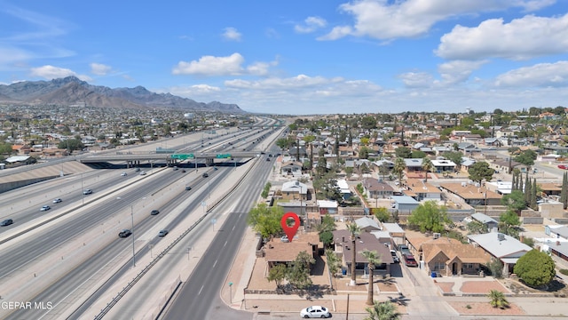 4301 Hueco Ave, El Paso, TX 79903 - aerial overview of property's location with a major roadway, nearby suburban area, and a mountain backdrop
