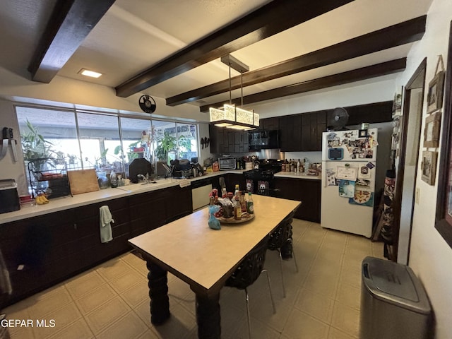3109 Park N Dr, El Paso, TX 79904 - kitchen featuring freestanding refrigerator, black microwave, dark cabinetry, beamed ceiling, and range