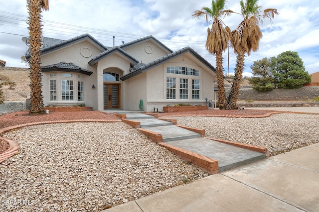 7413 Le Conte Dr, El Paso, TX 79912 - view of front facade with french doors, stucco siding, and a tile roof