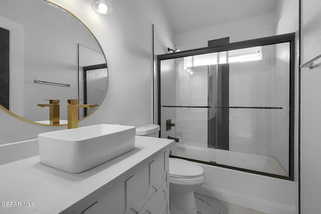 7413 Le Conte Dr, El Paso, TX 79912 - bathroom featuring toilet, vanity, bath / shower combo with glass door, and marble look tiles