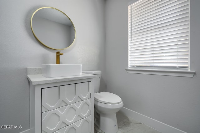 7413 Le Conte Dr, El Paso, TX 79912 - half bath with marble look tile flooring, baseboards, toilet, and vanity