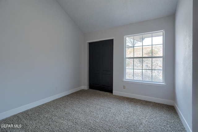 7413 Le Conte Dr, El Paso, TX 79912 - unfurnished room featuring carpet flooring, baseboards, and vaulted ceiling