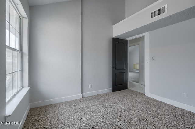 7413 Le Conte Dr, El Paso, TX 79912 - carpeted empty room with healthy amount of natural light and baseboards