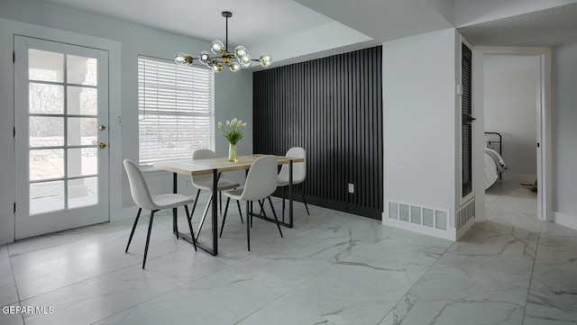 7413 Le Conte Dr, El Paso, TX 79912 - dining space featuring marble look tiles, a chandelier, and baseboards