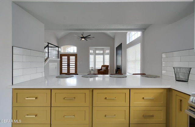 7413 Le Conte Dr, El Paso, TX 79912 - kitchen featuring a peninsula, light countertops, lofted ceiling, a ceiling fan, and open floor plan