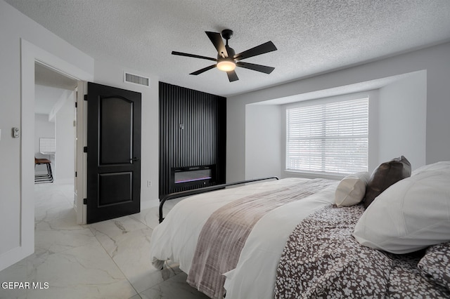 7413 Le Conte Dr, El Paso, TX 79912 - bedroom featuring light marble finish flooring, ceiling fan, baseboards, and a textured ceiling