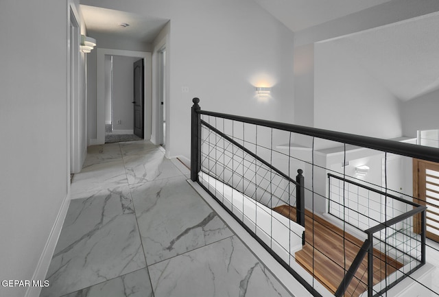 7413 Le Conte Dr, El Paso, TX 79912 - hallway featuring an upstairs landing, marble look tiles, and baseboards