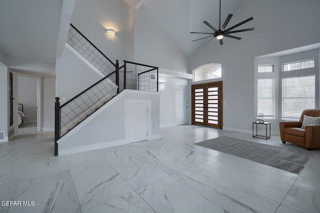 7413 Le Conte Dr, El Paso, TX 79912 - entrance foyer with marble look tiles, stairway, high vaulted ceiling, a ceiling fan, and baseboards