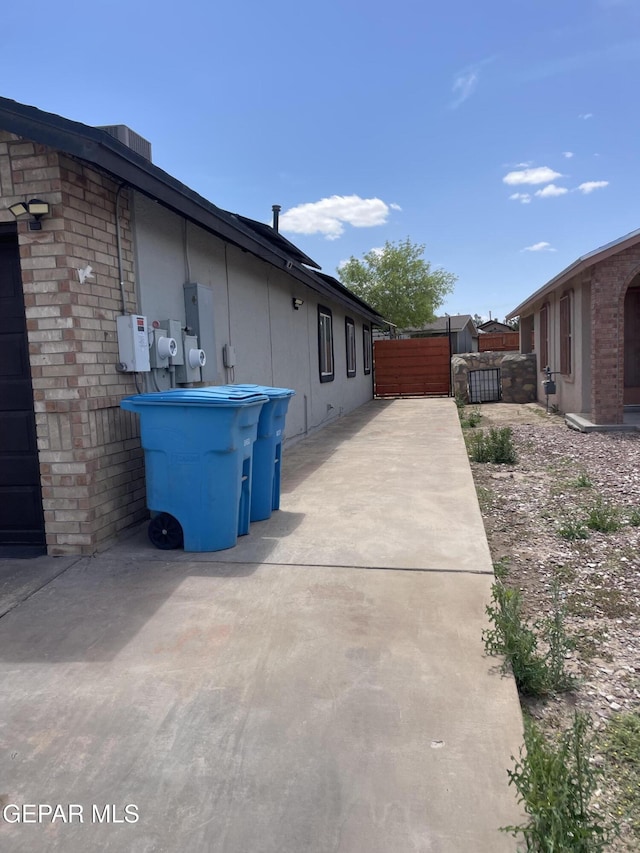 472 Valle Suave Dr, Socorro, TX 79927 - view of side of property featuring brick siding and a patio area