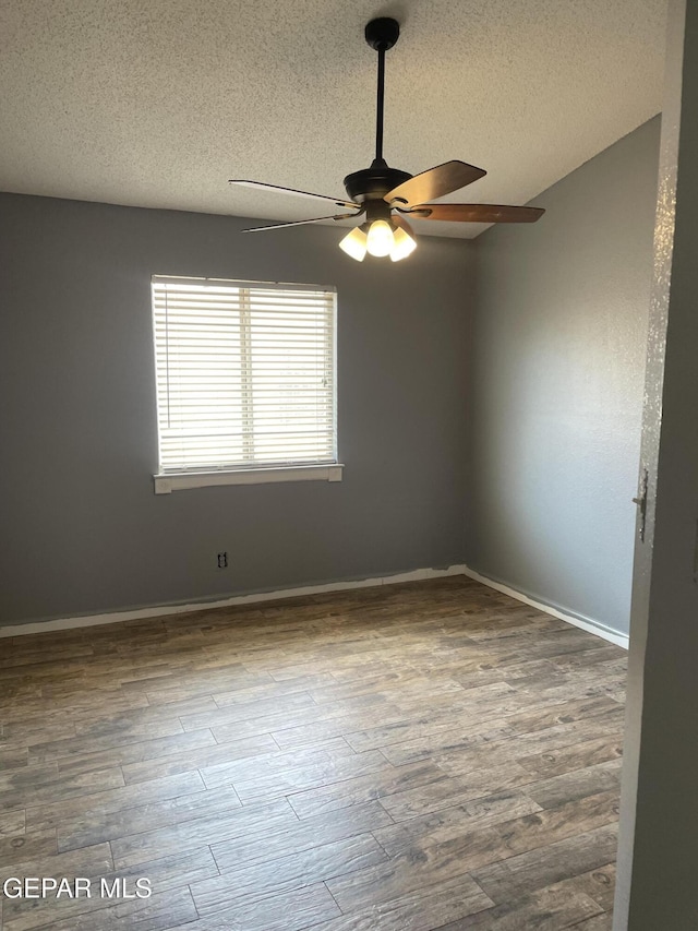 472 Valle Suave Dr, Socorro, TX 79927 - unfurnished room featuring a ceiling fan, a textured ceiling, wood finished floors, and baseboards