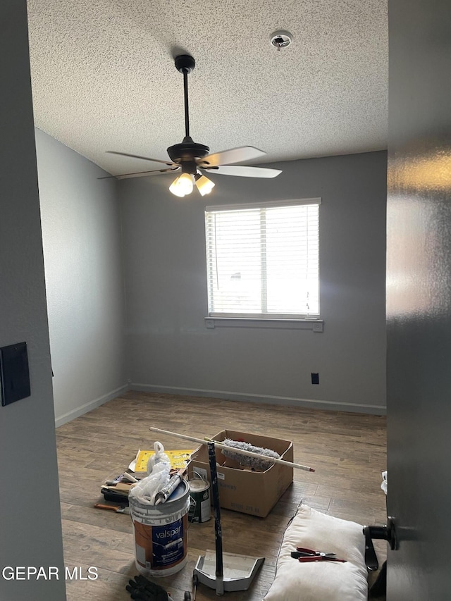472 Valle Suave Dr, Socorro, TX 79927 - unfurnished room with a ceiling fan, a textured ceiling, wood finished floors, and baseboards