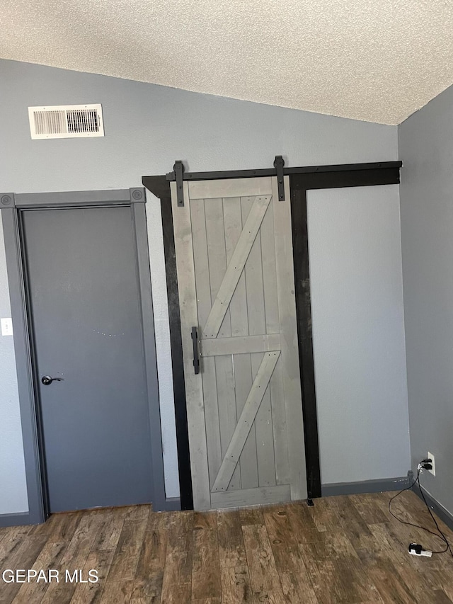 472 Valle Suave Dr, Socorro, TX 79927 - detailed view of wood finished floors and a barn door