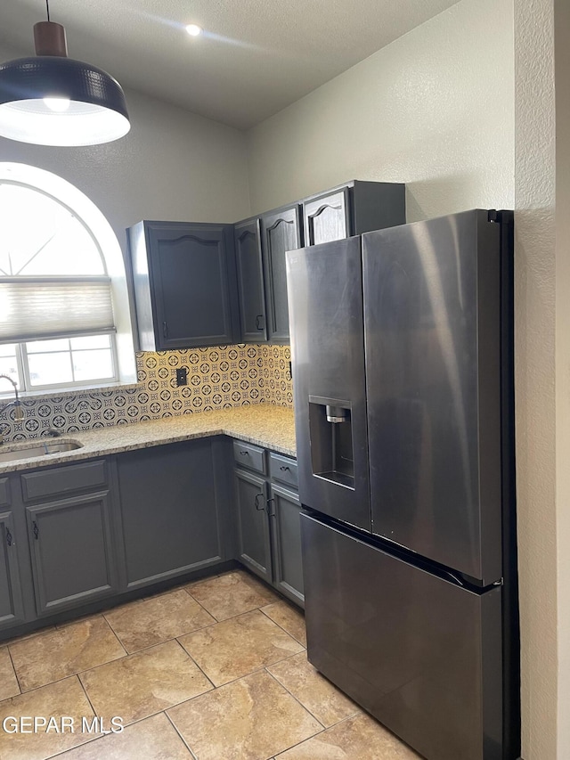 472 Valle Suave Dr, Socorro, TX 79927 - kitchen with stainless steel fridge with ice dispenser, a sink, tasteful backsplash, and gray cabinets