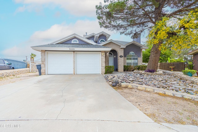 3020 Lake Travis Pl, El Paso, TX 79936 - traditional-style house featuring fence, driveway, an attached garage, and brick siding