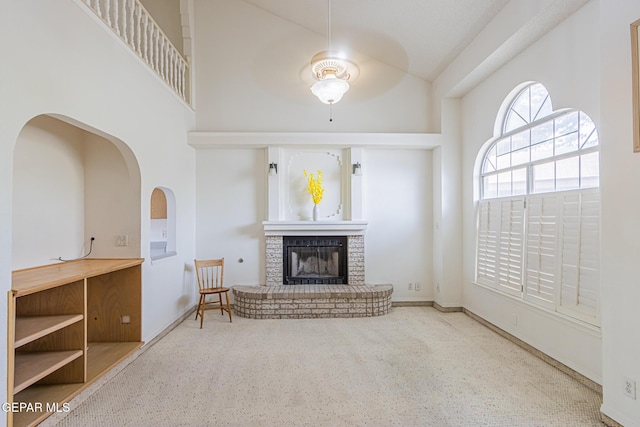 3020 Lake Travis Pl, El Paso, TX 79936 - living room featuring a ceiling fan, a fireplace, high vaulted ceiling, and baseboards