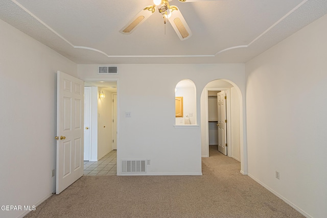 3020 Lake Travis Pl, El Paso, TX 79936 - empty room featuring light carpet, a ceiling fan, arched walkways, and baseboards