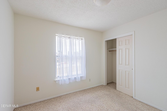 3020 Lake Travis Pl, El Paso, TX 79936 - unfurnished bedroom featuring carpet, a closet, baseboards, and a textured ceiling