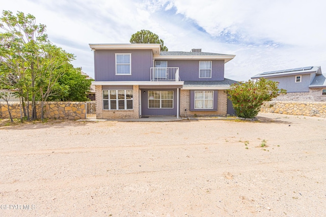 3020 Lake Travis Pl, El Paso, TX 79936 - view of front facade featuring a balcony, fence, and brick siding