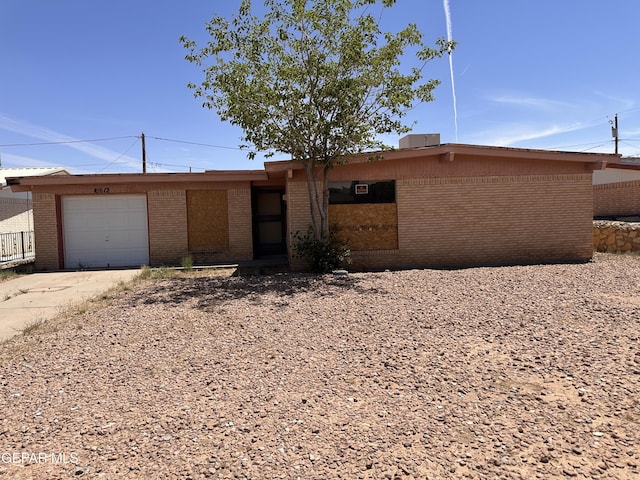 10612 Elsa Pl, El Paso, TX 79924 - mid-century modern home with brick siding, driveway, and an attached garage