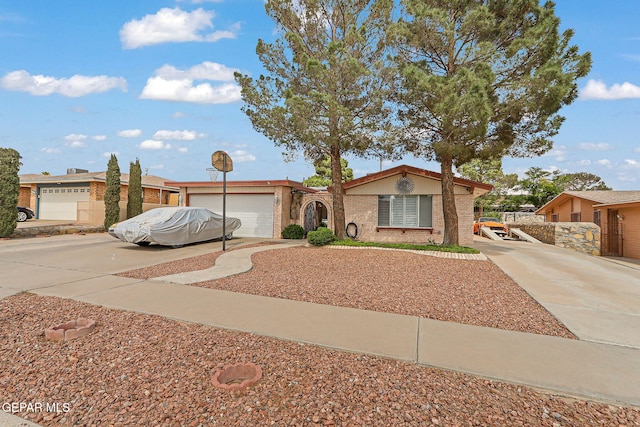 1664 Lou Graham Dr, El Paso, TX 79936 - view of front of house with concrete driveway, brick siding, and a garage